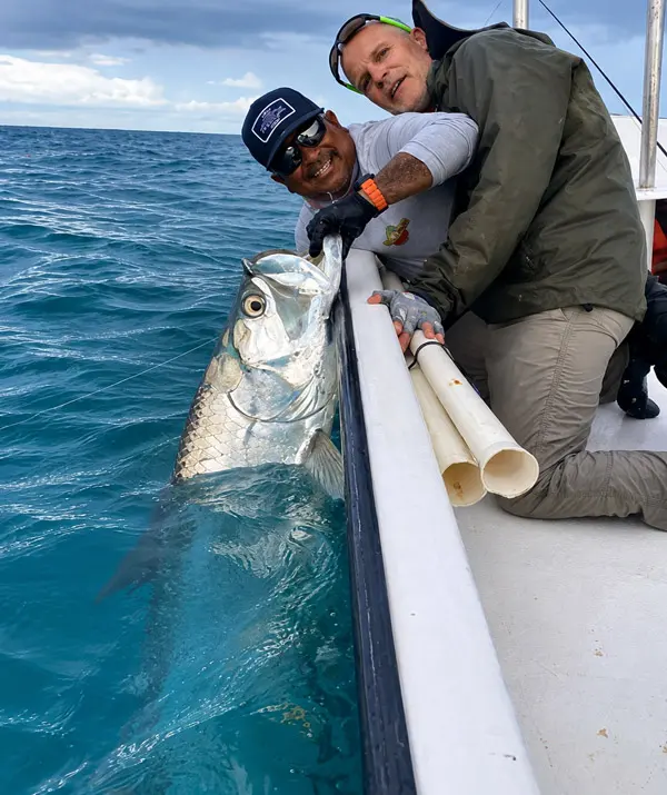 Guide and client showing off a BIG Tarpon